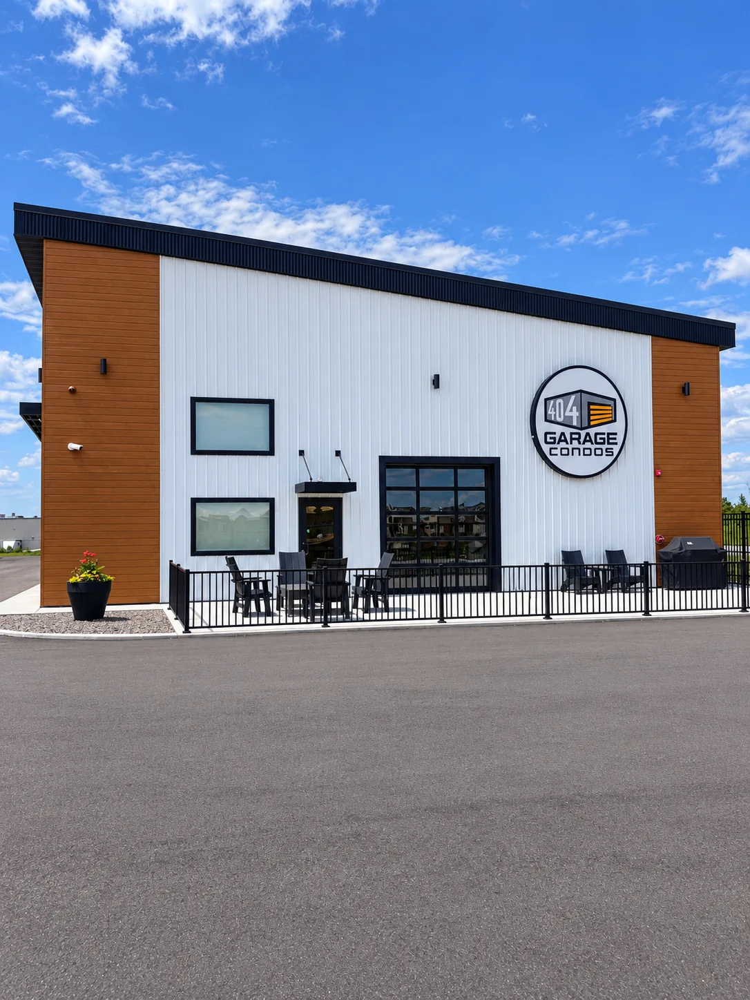 404 clubhouse facade with patio seating and a black metal fence