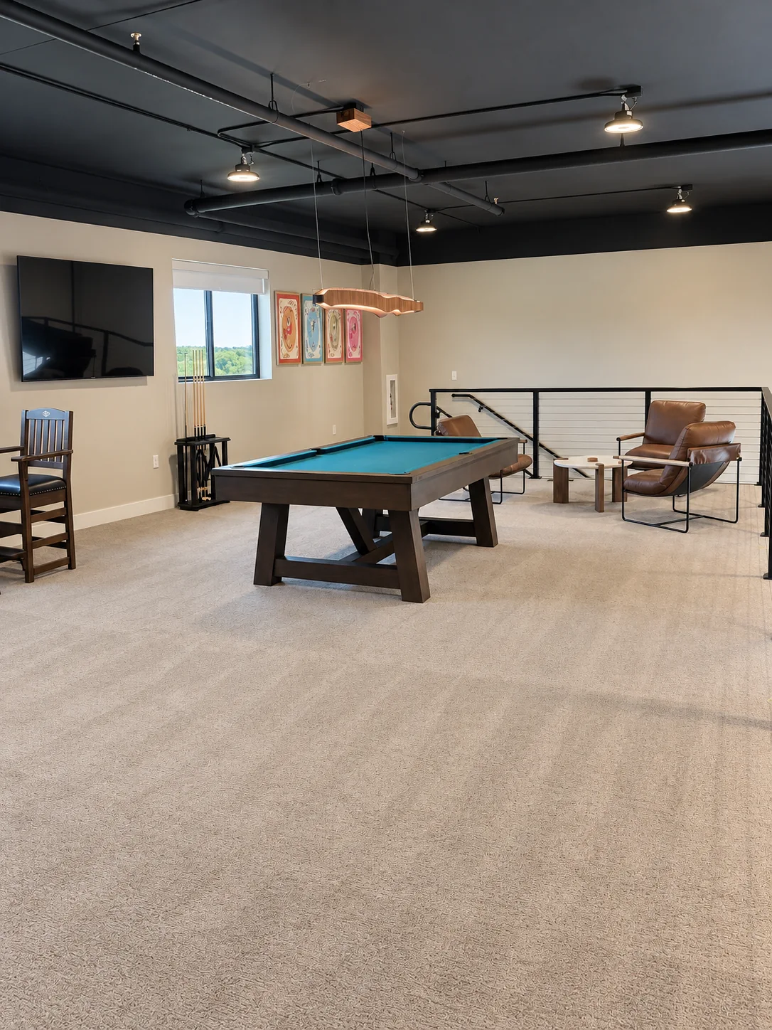 Pool table and leather chairs in the upstairs clubhouse lounge