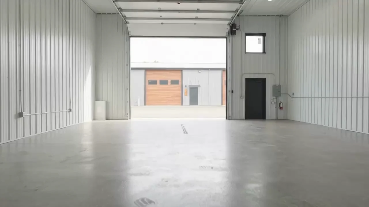 Heated garage interior with an open overhead door at 404 in Sauk Rapids